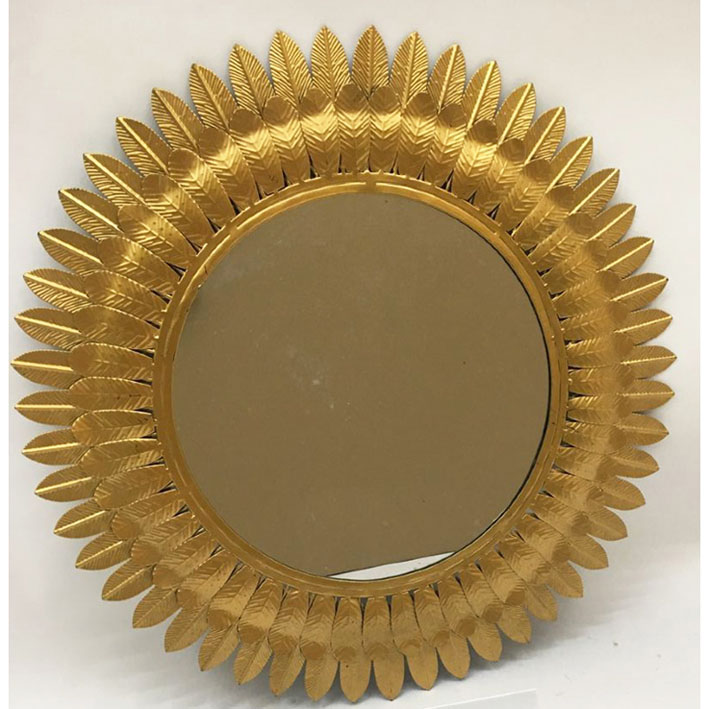 Shiny gold metal mirror with leaves around the edge