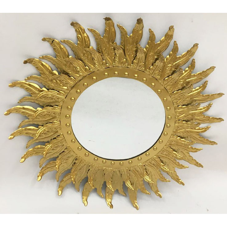 Shiny gold metal mirror with leaves around the edge