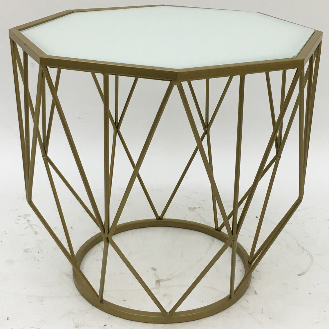 Gold octagonal metal coffee table with clear glass top and X metal side